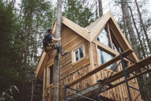 man working on treehouse