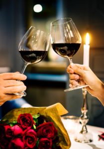 valentine's day: two people clinking their wine glasses