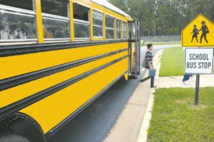 weather make-up days: yellow school bus with a kid getting off