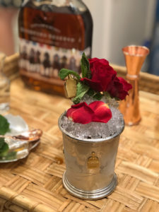 a silver cup with ice and flowers