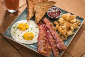 first watch: breakfast plate with eggs, bacon, toast, and potatoes