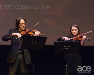 LexArts: two people playing the violin on stage