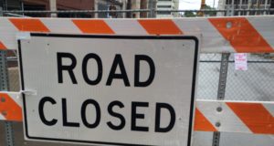 construction sign that says road closed