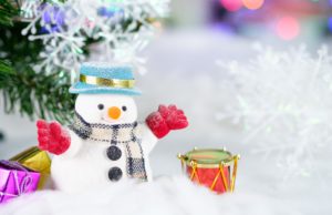 snow man with a red gloves and a drum