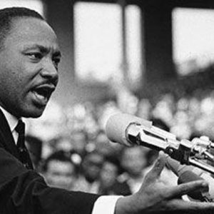 mlk: martin luther king, jr. giving his famous speech at the podium in black and white
