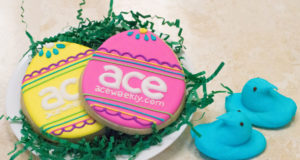 egg shaped cookies with colorful icing that say ace on it