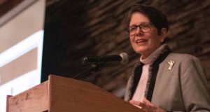 Women Leading Kentucky: woman in a blazer talking at a podium
