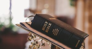 bible on a stand and a blurry background