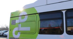 Air Quality: a white bus with a green circle with a white shape in the middle