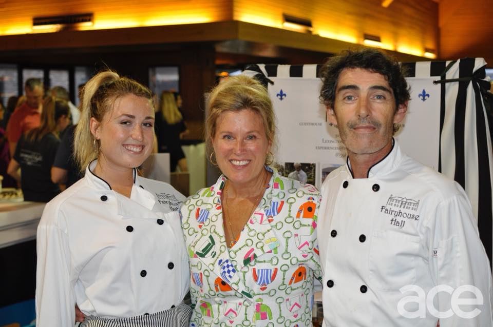three people in chef tops smiling at the camera
