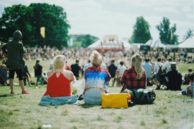 Railbird: group of girls sitting on the grass at a music festival