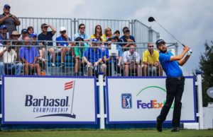 man playing golf with a Barbasol Championship sign in the background