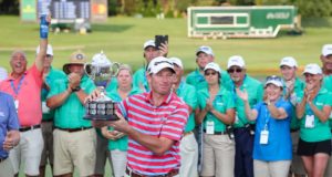 Barbasol: a golfer holding a trophey with people behind him