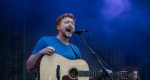 Tyler Childers with a guitar singing