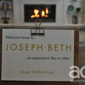 sign that says Joseph-Beth and a fireplace behind