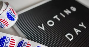 Gubernatorial: a black board that says voting day with voted stickers