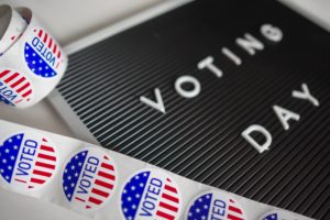 Gubernatorial: a black board that says voting day with voted stickers