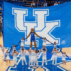 basketball: a big UK flag with a pyramid of cheerleaders and a mascot