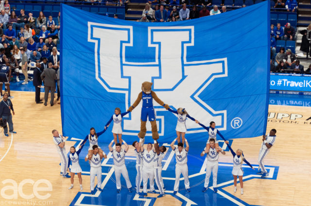 basketball: a big UK flag with a pyramid of cheerleaders and a mascot